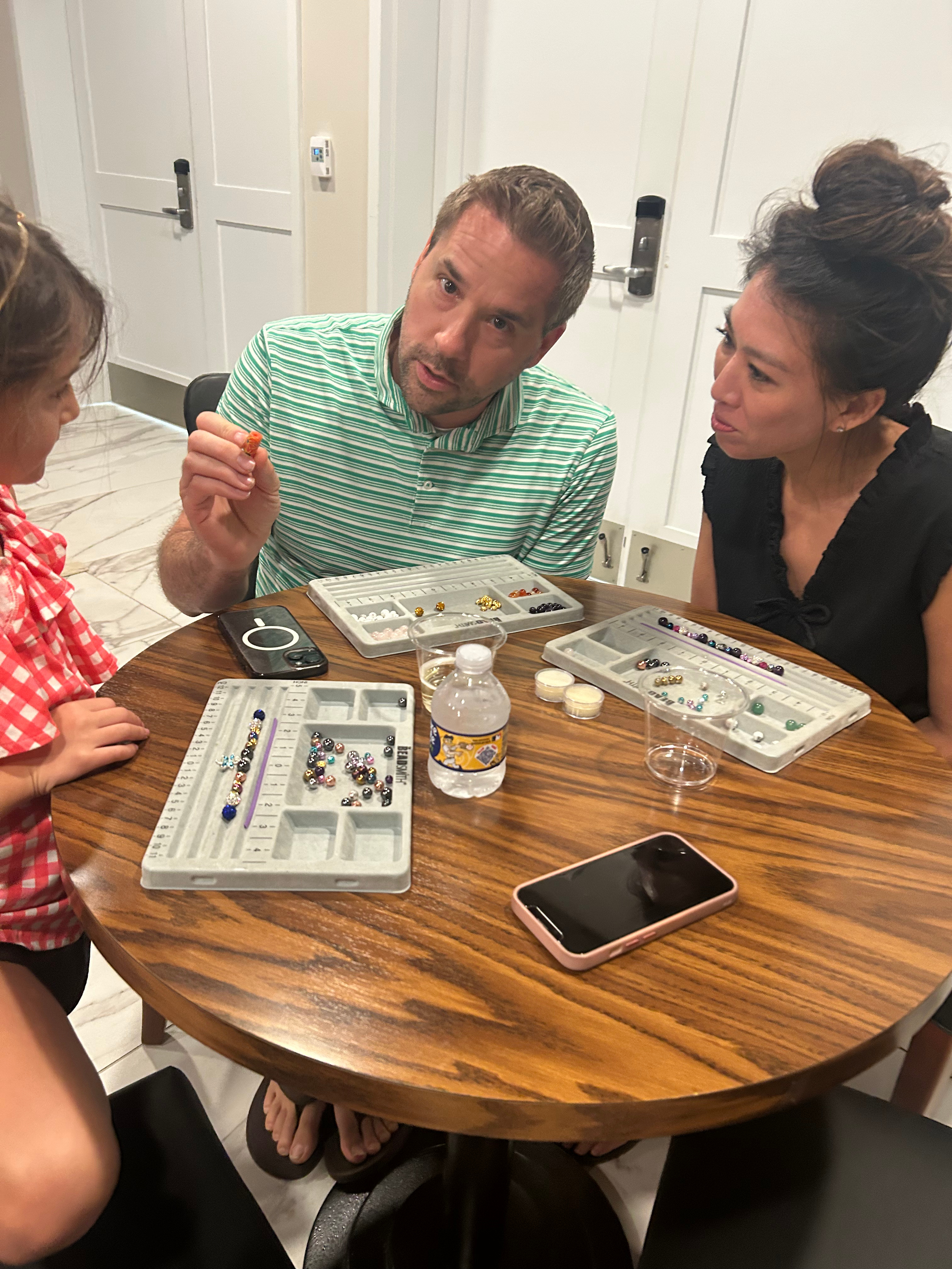 Family making bracelets together