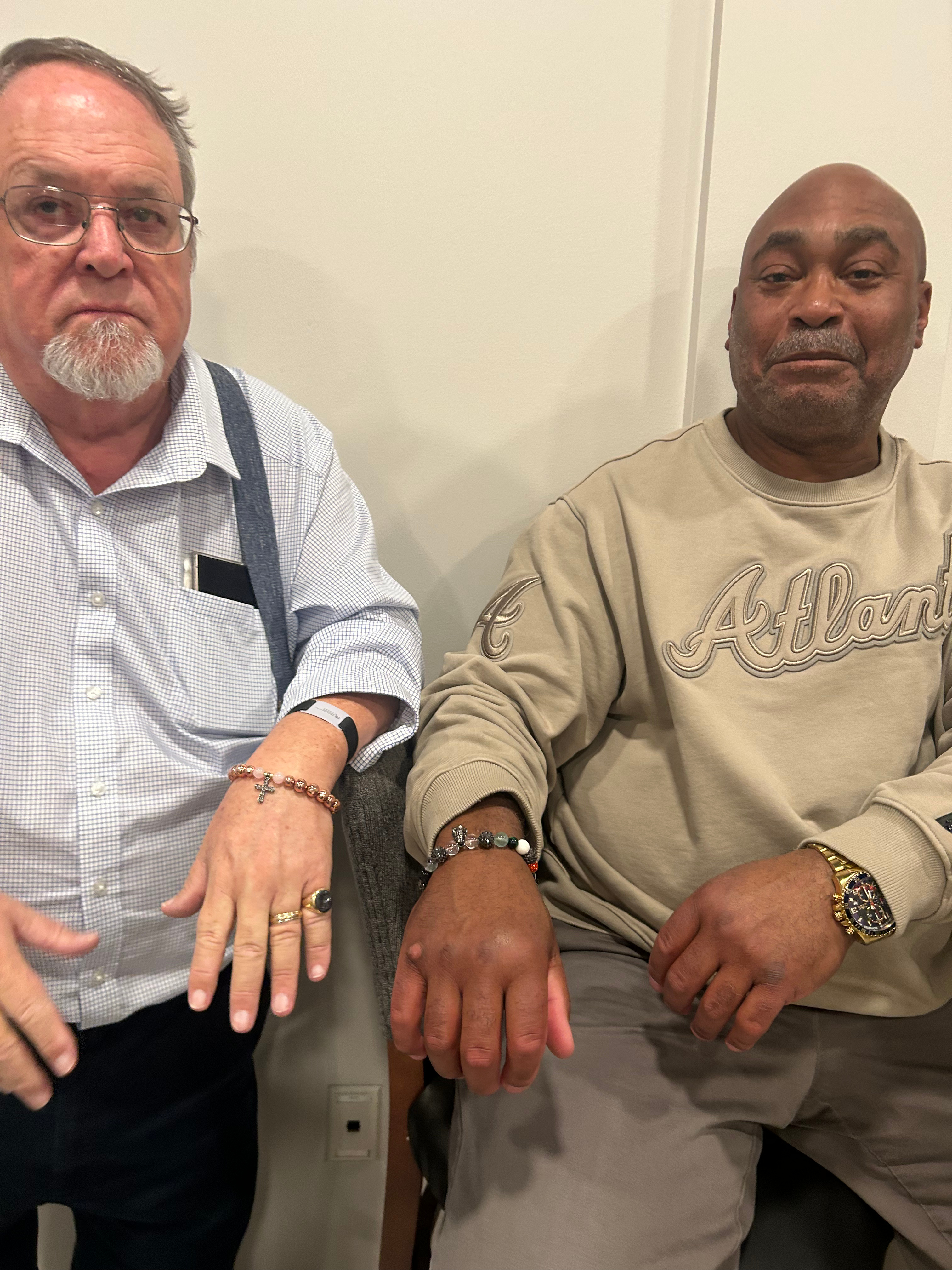 Men showing off their handmade bracelets